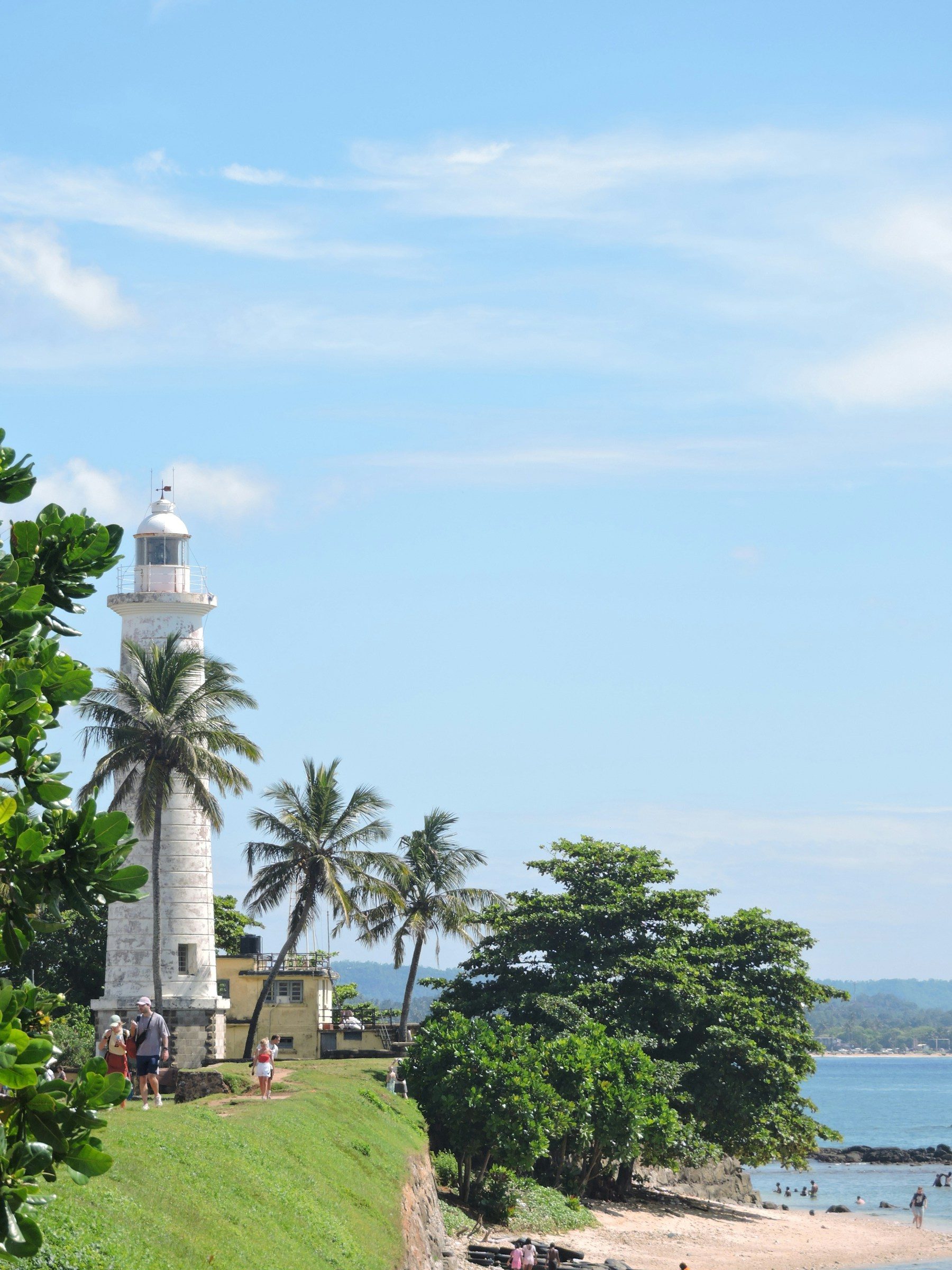 Galle Lighthouse, palms and the coastline beside the old fort