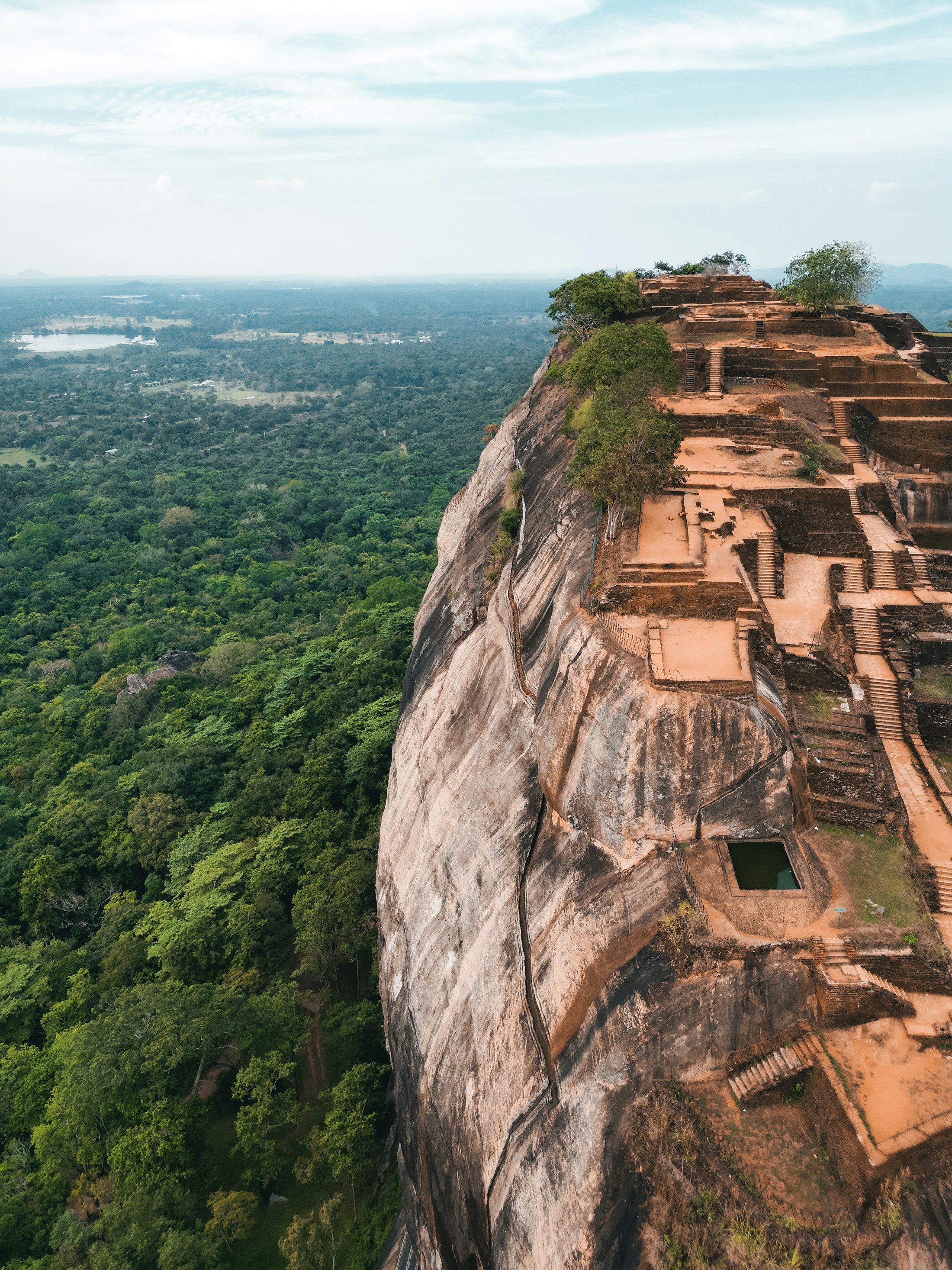 Ancient ruins on top of Sigiriya rock, surrounded by forest